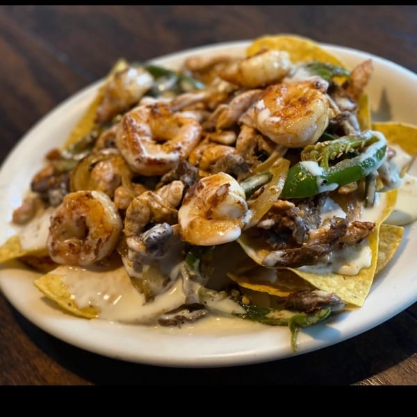 Lomeli's Mexican Bar and Grill's shrimp nachos with cheese sauce, peppers, and onions.