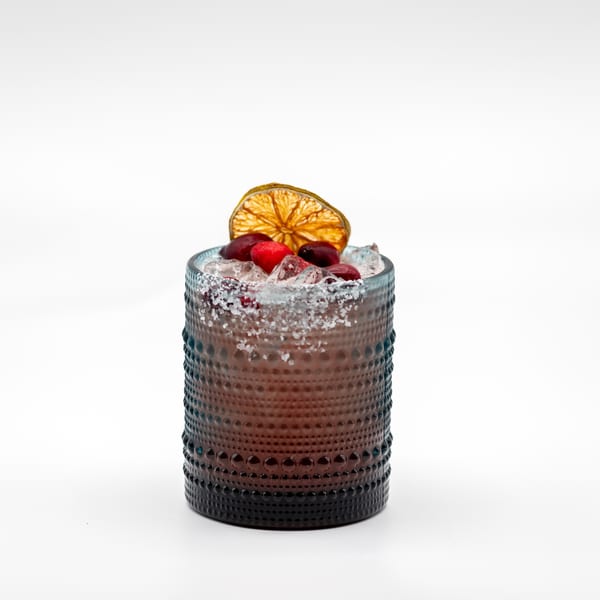 Lomeli's Mexican Bar and Grill cocktail with cranberries, dried orange, and a salted rim.