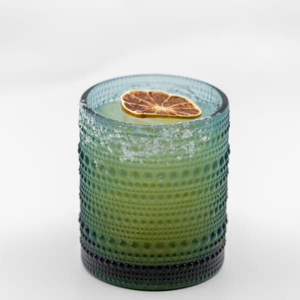 Lomeli's Mexican Bar and Grill's margarita in a textured green glass with a dried lime slice.