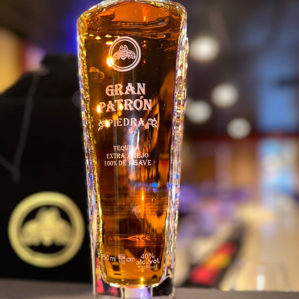 Close-up of a Gran Patrón Piedra Extra Añejo tequila bottle, showcasing its label and amber liquid.